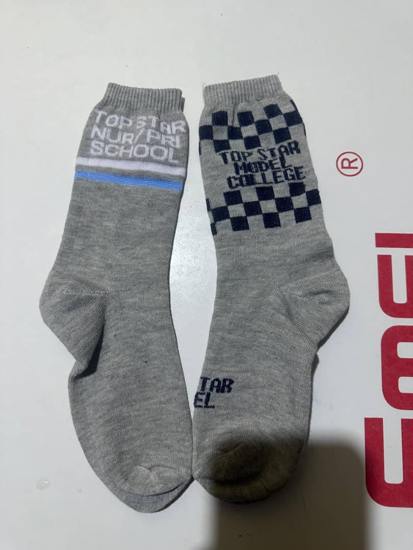 Grey school socks with navy checkerboard pattern and Top Star Model College knitted in